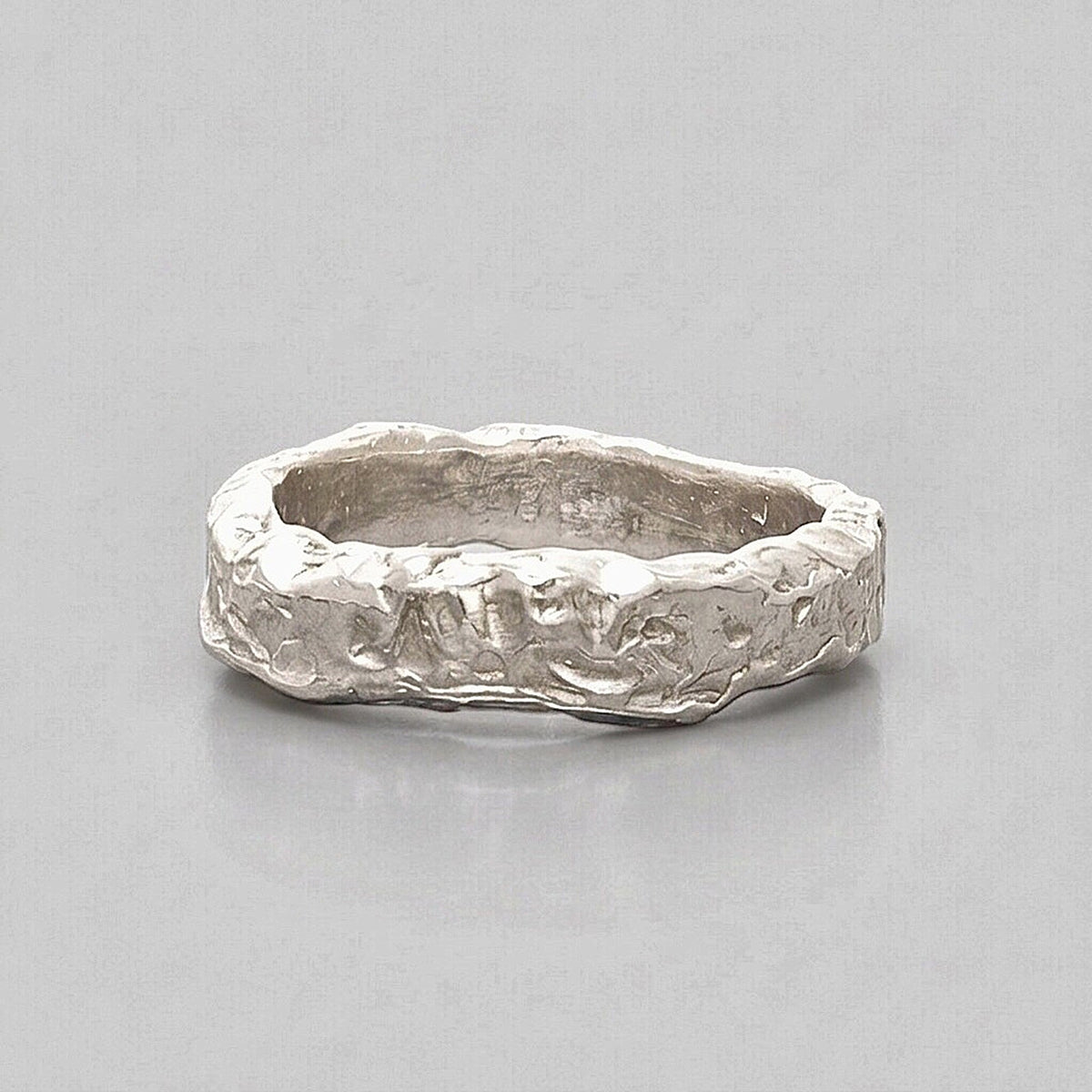 Anillo Superficie Solar de plata de ley 925 con textura escultural sobre fondo gris